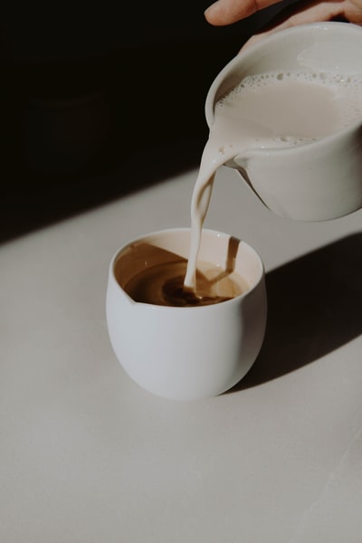 Brown liquid white ceramic cup
